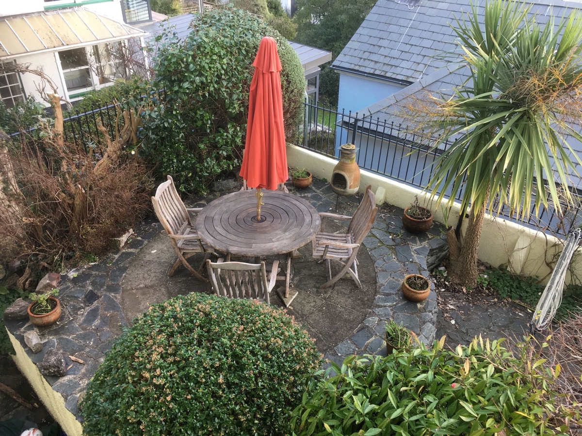 A terrace with a table and four chairs